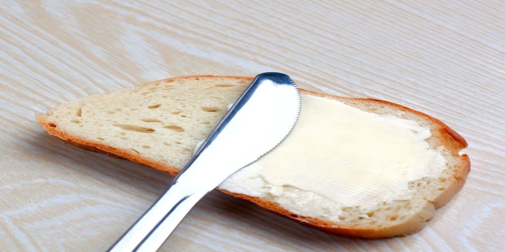A picture of a knife spreading butter on a plain piece of bread to remind us that sameness is valuable